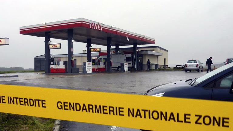 A police cordon is seen at an Avia gas station in Villers-Cotterets, north-east of Paris, on January 8, 2015, where the two armed suspects from the attack on French satirical weekly newspaper Charlie Hebdo were spotted in a car