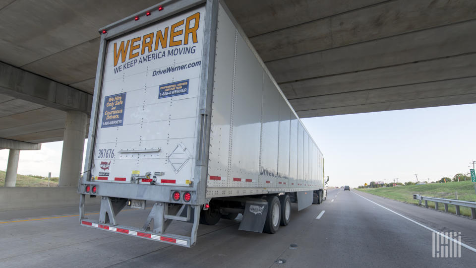 A Werner tractor-trailer moving under an underpass