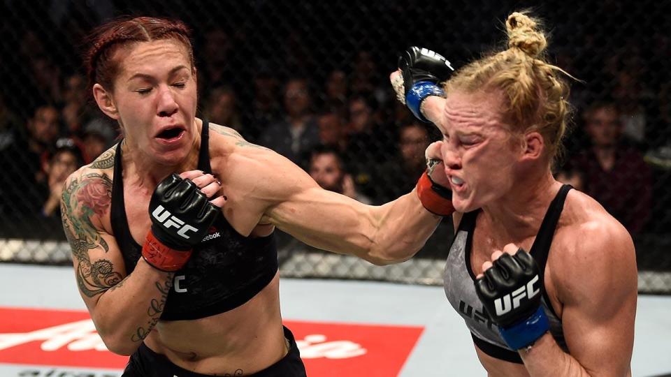 Cris “Cyborg” Justino (L) got a true test from Holly Holm, but the featherweight champ prevailed in the end. (Getty)