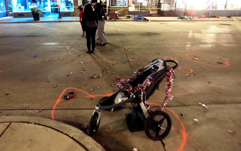 A broken children's stroller lays on W. Main St. in downtown Waukesha - John Hart /Wisconsin State Journal 