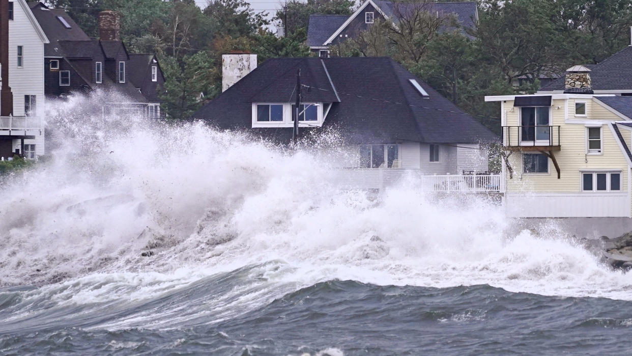 Waves slam the shore in Scituate, Mass., near high tide on Thursday.