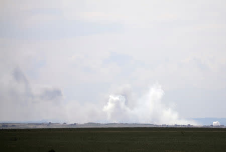 Plumes of smoke rise near Baghouz, Deir Al Zor province, Syria February 11, 2019. REUTERS/Rodi Said