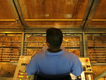 A worker observes the operation of a mechanical claw from a control centre perched over a pit of waste at the Tuas South incineration plant in Singapore April 21, 2008. The plant incinerates waste into ash, which is then transported to Semakau Island and deposited into a landfill. REUTERS/Vivek Prakash