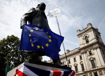 An EU flag is draped across the statue of Winston Chruchill in Parliament Square, as EU supporters, calling on the government to give Britons a vote on the final Brexit deal, participate in the 'People's Vote' march in central London, Britain June 23, 2018. REUTERS/Henry Nicholls