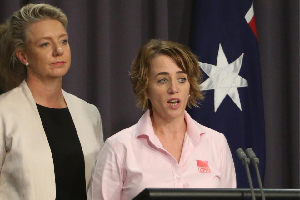 Australian Agriculture Minister Bridget McKenzie, left, and pork industry executive Margo Andrae address the media at Parliament House in Canberra, Australia Tuesday, Oct. 15, 2019, on the threat of African swine fever. Australia for the first time has canceled a tourist's visa over undeclared food as the country tries to keep itself free of the disease. (AP Photo/Rod McGuirk)