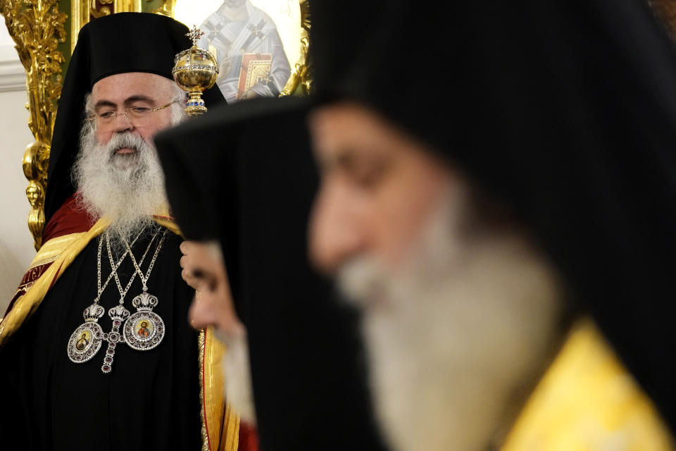 The head of Cyprus' Orthodox Church Archbishop Georgios, left, looks on during his enthronement ceremony at Saint Barnabas Cathedral in capital Nicosia, Cyprus, Sunday, Jan. 8, 2023. Archbishop Georgios formally assumed his new duties following an enthronement ceremony evoking the splendor of centuries of Byzantine tradition before an audience of Orthodox clergy from around the world with the notable exception of the Russian church. The Cyprus Church has recognized the independence of the Orthodox Church of Ukraine. (AP Photo/Petros Karadjias)