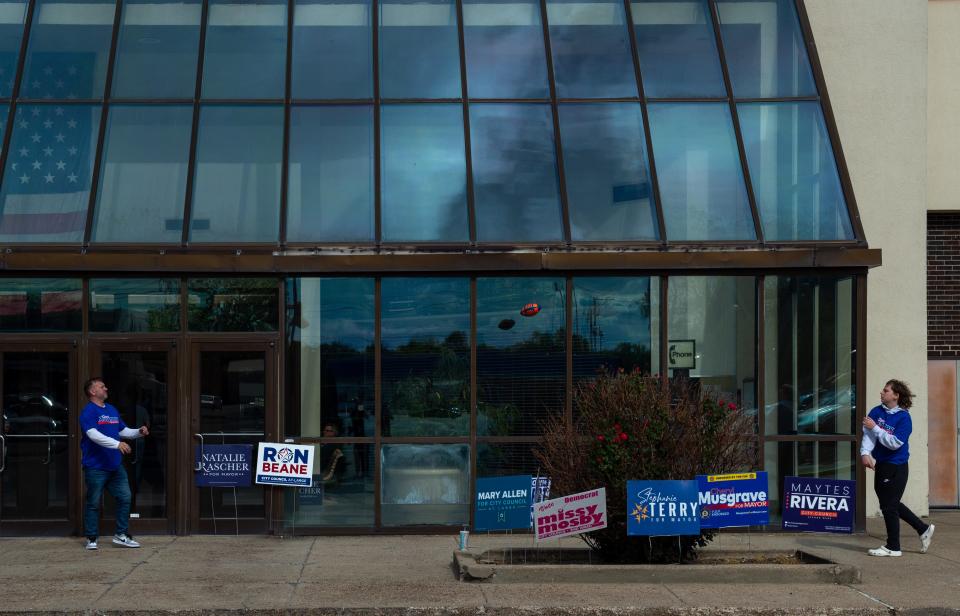 Jackson Harris, right, tosses a football to father Jarid Harris while campaigning for Evansville Republican candidate for mayor Cheryl Musgrave outside Washington Square Mall for Evansville’s primary election, Tuesday afternoon, May 2, 2023.