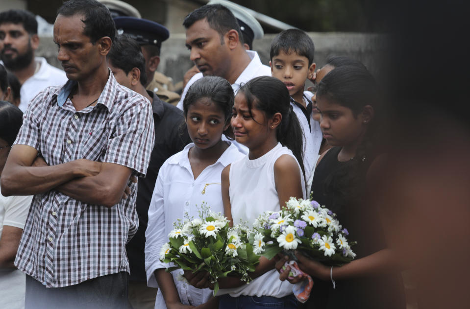 Friends of Dhami Brandy, 13, who was killed during Easter Sunday's bomb blast at St. Sebastian Church, cries during funeral service in Negombo, Sri Lanka Thursday, April 25, 2019. The U.S. Embassy in Sri Lanka warned Thursday that places of worship could be targeted for militant attacks over the coming weekend, as police searched for more suspects in the Islamic State-claimed Easter suicide bombings that killed over 350 people. (AP Photo/Manish Swarup)