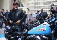 Singer Billy Joel gets off a motorcycle after riding from the Rescue 1 firehouse on West 43rd Street downtown to Ground Zero to honor the victims of the 9/11 attacks, outside the World Trade Center site in New York September 11, 2013. Bagpipes, bells and a reading of the names of the nearly 3,000 people killed when hijacked jetliners crashed into the World Trade Center, the Pentagon and a Pennsylvania field marked the 12th anniversary of the September 11 attacks in 2001. (REUTERS/Shannon Stapleton)