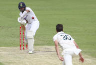 India's Cheteshwar Pujara plays at the ball bowled by Australia's Pat Cummins during play on day two of the fourth cricket test between India and Australia at the Gabba, Brisbane, Australia, Saturday, Jan. 16, 2021. (AP Photo/Tertius Pickard)