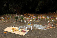 Offerings are place during the funeral a former Thai navy diver, Samarn Kunan, who died during the rescue mission for the 12 boys of the "Wild Boars" soccer team and their coach, near the Tham Luang cave complex, in the northern province of Chiang Rai, Thailand July 16, 2018. REUTERS/Tyrone Siu