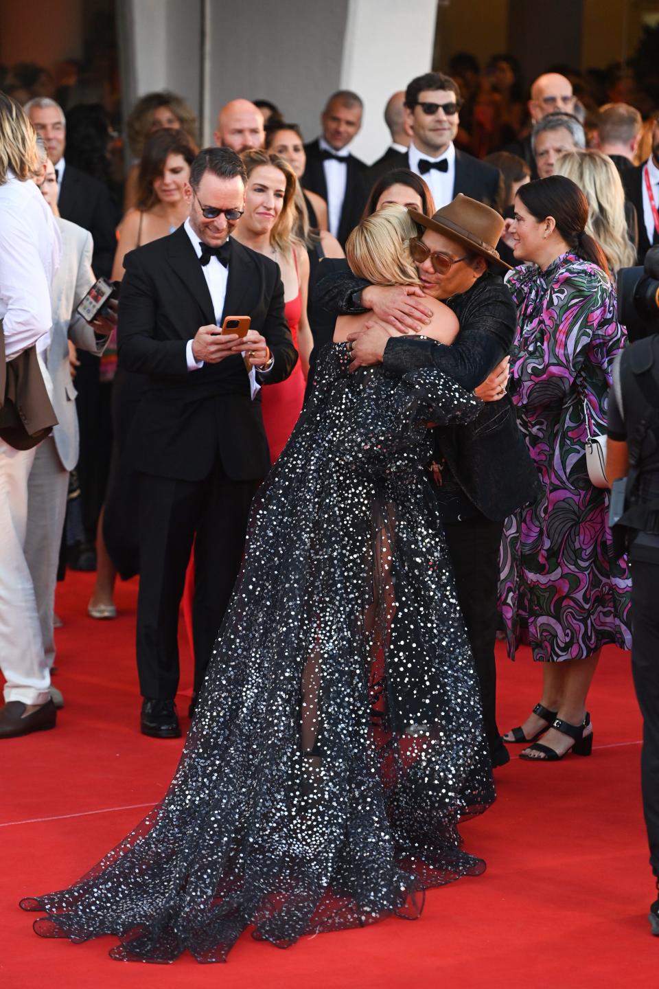 Florence Pugh greets Matthew Libatique on the "Don't Worry Darling" red carpet at the 2022 Venice Film Festival.