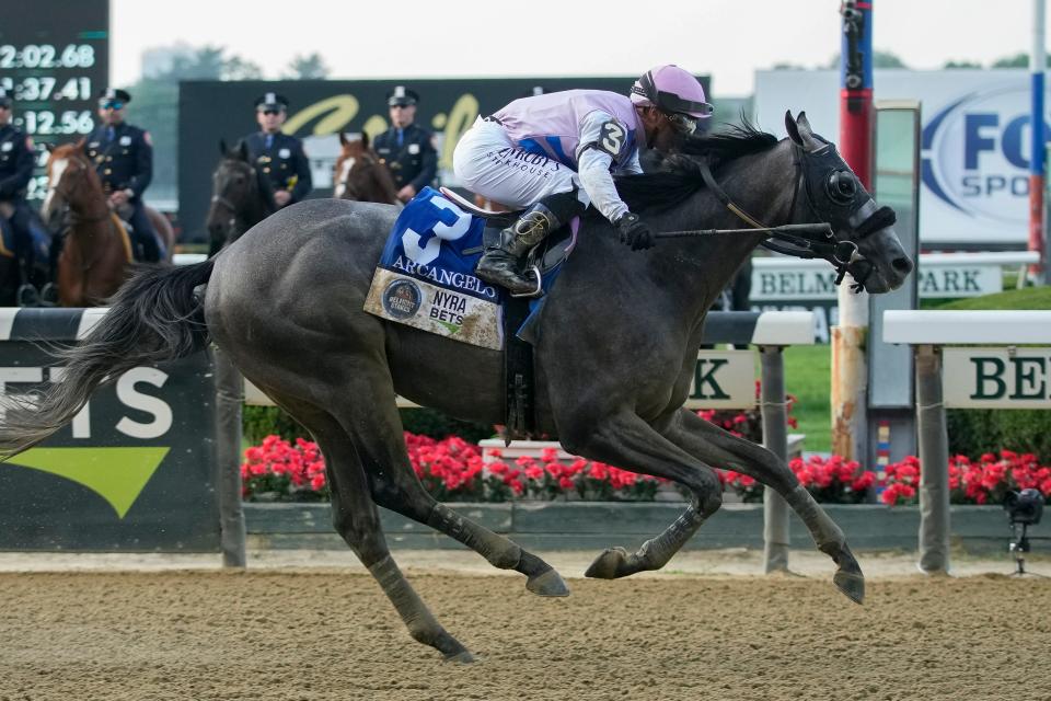 Arcangelo, with jockey Javier Castellano, crosses the finish line to win the Belmont Stakes.