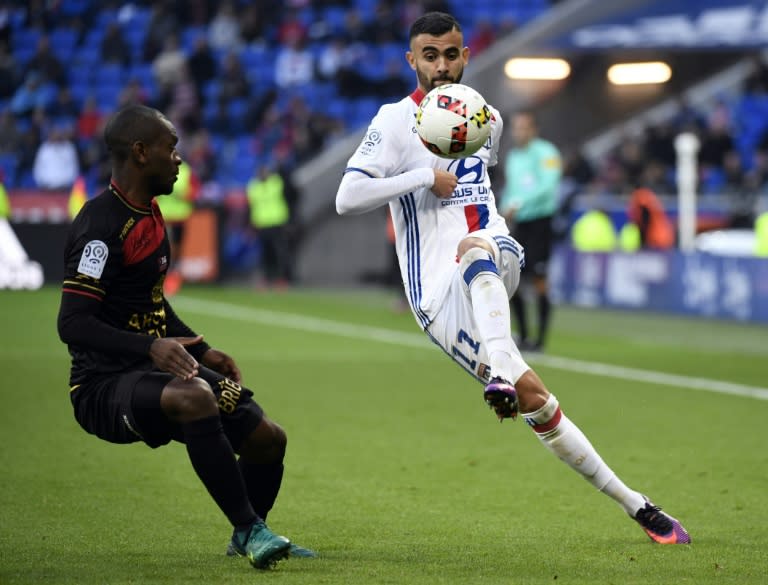 Lyon's Rachid Ghezzal (R) tries to get past Guingamp's Jordan Ikoko during the match on October 22, 2016, in Decines-Charpieu