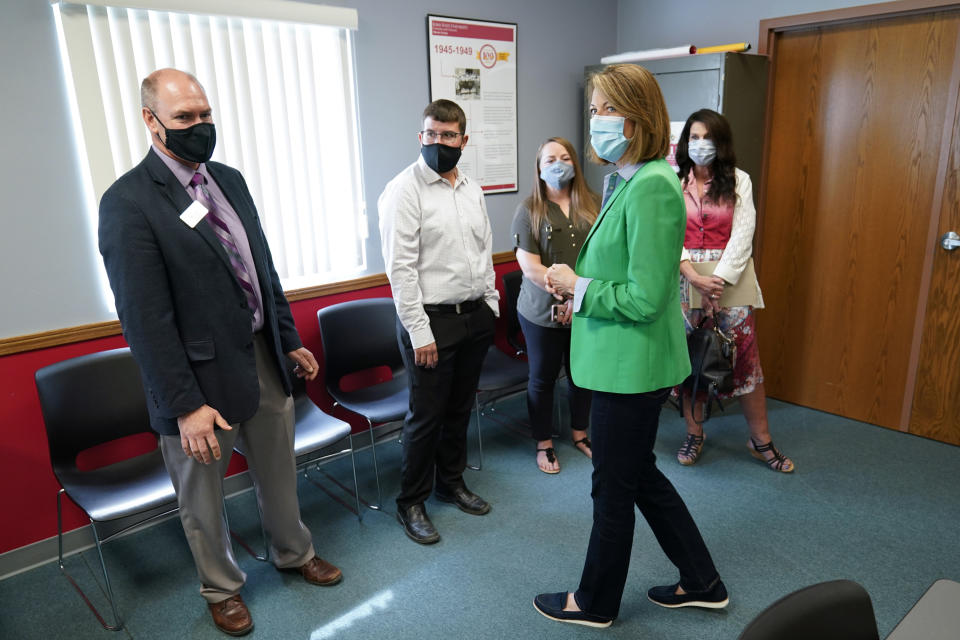 In this Sept. 2, 2021, photo Rep. Cindy Axne, D-Iowa, speaks about the Rural Reinvestment Task Force during a meeting with local officials in Indianola, Iowa. (AP Photo/Charlie Neibergall)