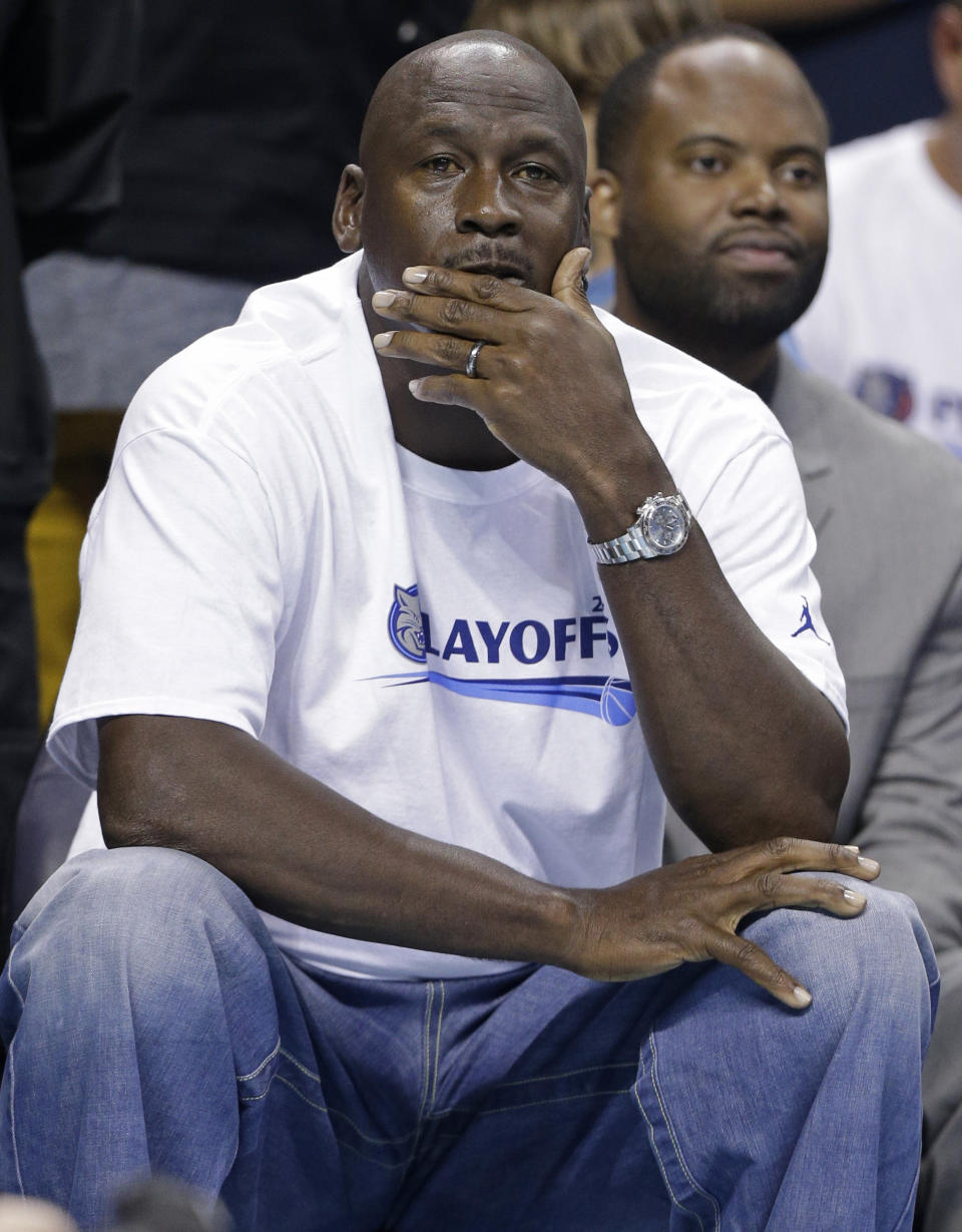 Charlotte Bobcats owner Michael Jordan watches the action during the first half in Game 4 of the Bobcats' opening-round NBA basketball playoff series against the Miami Heat in Charlotte, N.C., Monday, April 28, 2014. (AP Photo/Chuck Burton)