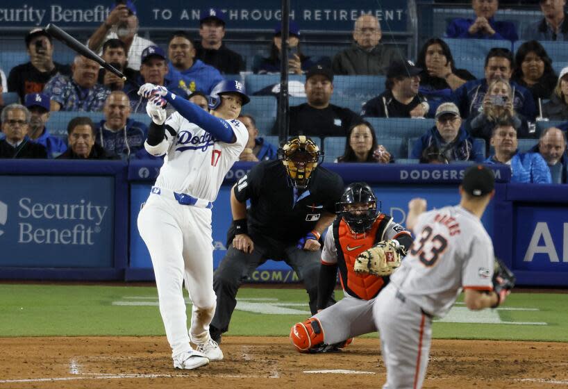 Los Angeles, CA - April 03: Dodgers designated hitter Shohei Ohtani, #17, hits his first home run off of Giants pitcher Taylor Rogers, # 33, in the seventh inning at Dodger Stadium in Los Angeles Wednesday, April 3, 2024. (Allen J. Schaben / Los Angeles Times)