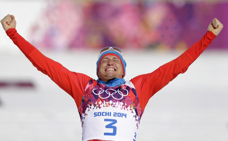 Russia's Alexander Legkov celebrates winning the gold during the flower ceremony of the men's 50K cross-country race at the 2014 Winter Olympics, Sunday, Feb. 23, 2014, in Krasnaya Polyana, Russia. (AP Photo/Matthias Schrader)