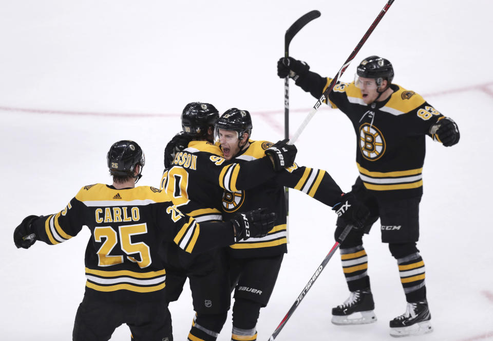 Boston Bruins left wing Marcus Johansson, second from left, is congratulated by teammates after his goal off Toronto Maple Leafs goaltender Frederik Andersen during the first period of Game 7 of an NHL hockey first-round playoff series, Tuesday, April 23, 2019, in Boston. (AP Photo/Charles Krupa)