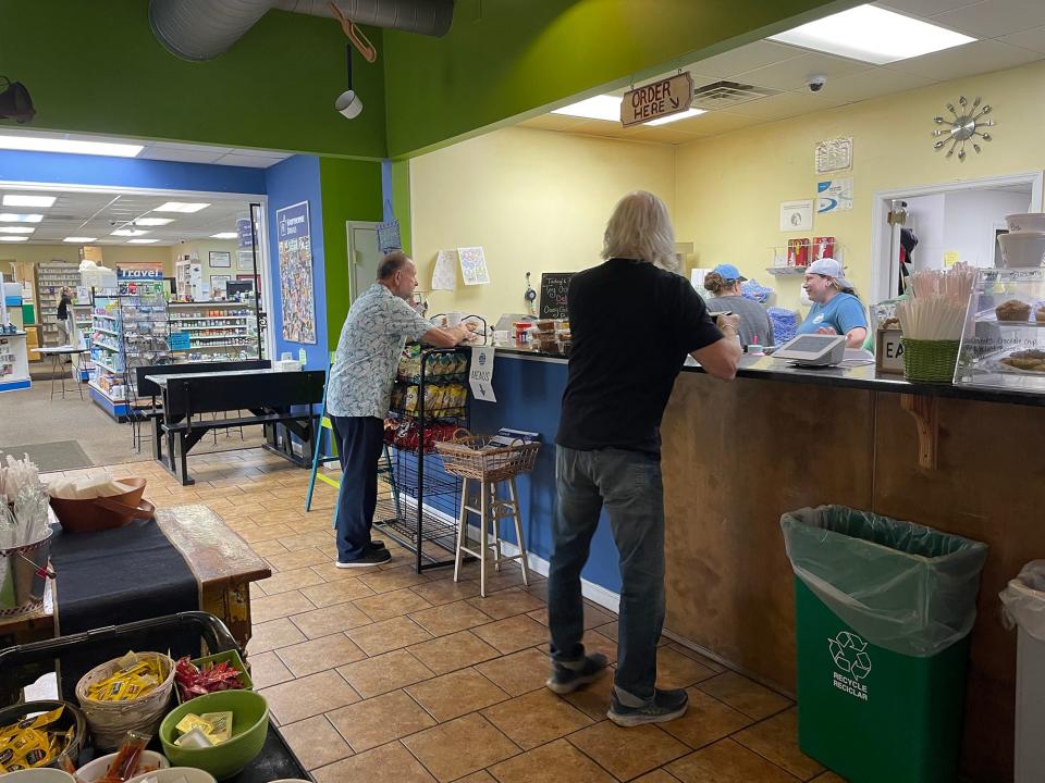 Guests place their orders at Em's Kitchen in Athens, Ga. on Tuesday, Aug. 29, 2023. The restaurant began as a soda fountain in Hawthorne Drugs, which can be seen on the left.