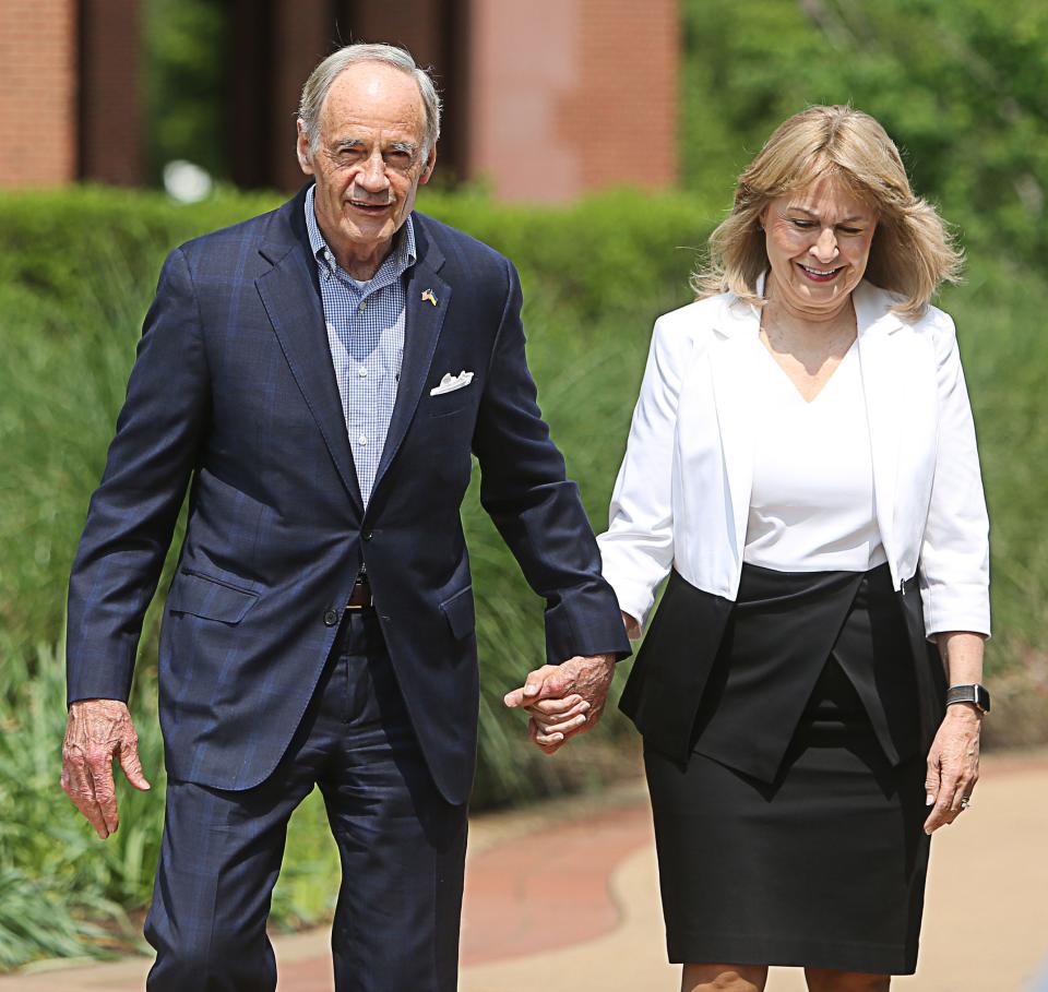 Sen. Tom Carper, joined by his wife, Martha Carper, walks to the podium for a press conference on Monday, May 22, 2023, where he announced that he will not seek reelection.