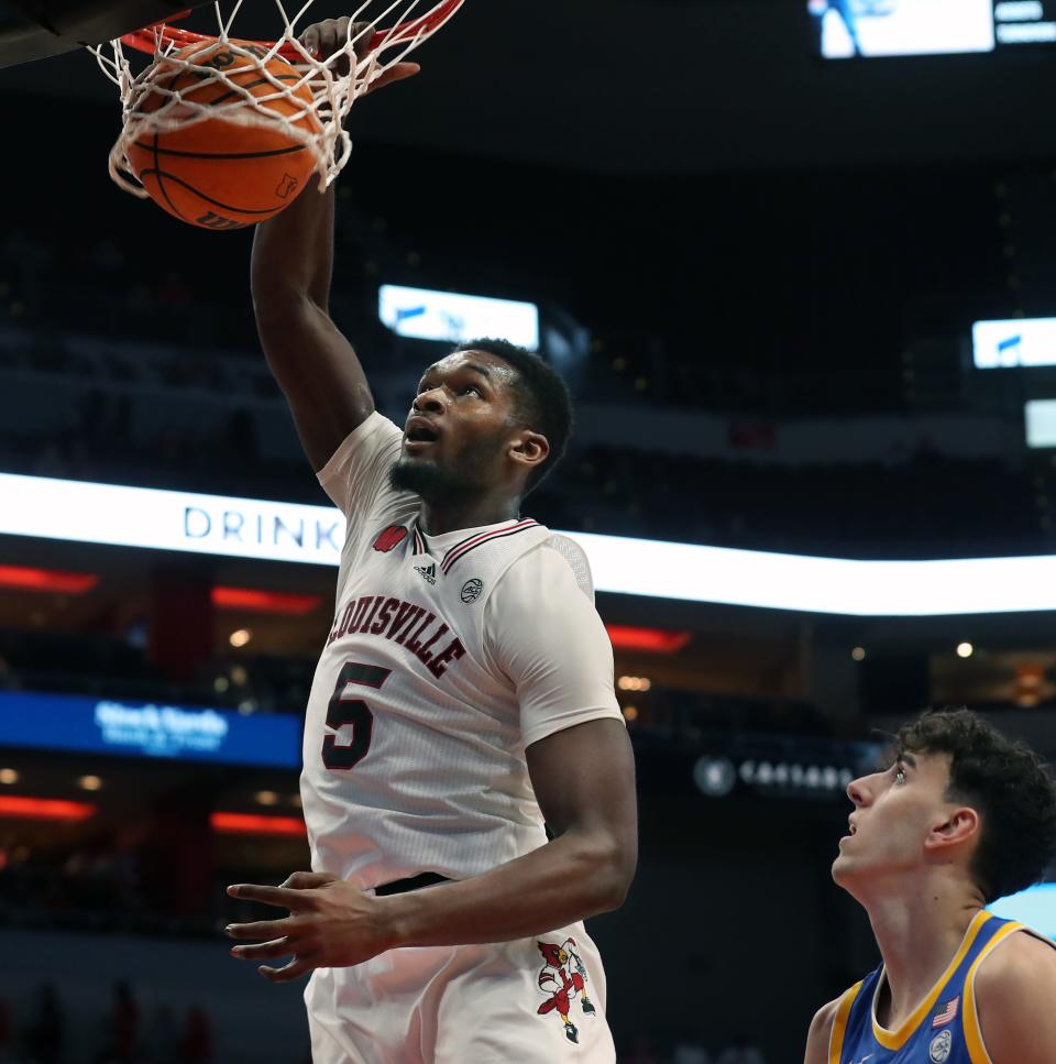 Louisville’s Brandon Huntley-Hatfield makes a bucket against Pitt’s Jorge Diaz Graham on Saturday at the KFC Yum! Center.