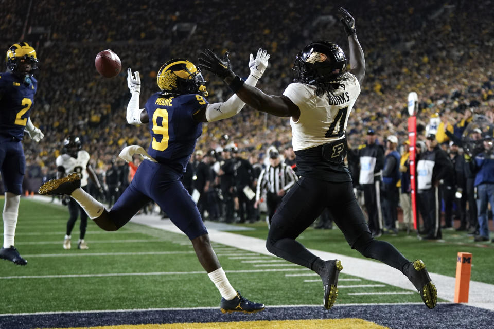 Michigan defensive back Rod Moore (9) breaks up a pass intended for Purdue wide receiver Deion Burks (4) in the first half of an NCAA college football game in Ann Arbor, Mich., Saturday, Nov. 4, 2023. (AP Photo/Paul Sancya)