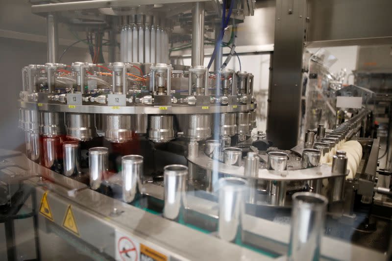 Beverage cans are run through machinery during a tour at a Canopy Growth facility