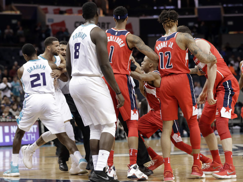 Players and officials try to separate Charlotte Hornets’ Michael Carter-Williams, second from left, and Washington Wizards’ Tim Frazier, third from right, after a scuffle during the second half of an NBA basketball game in Charlotte, N.C., Wednesday, Jan. 17, 2018. Both players were ejected from the game. (AP)