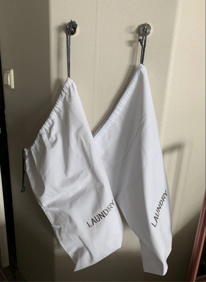 laundry cloth bags hanging on hooks