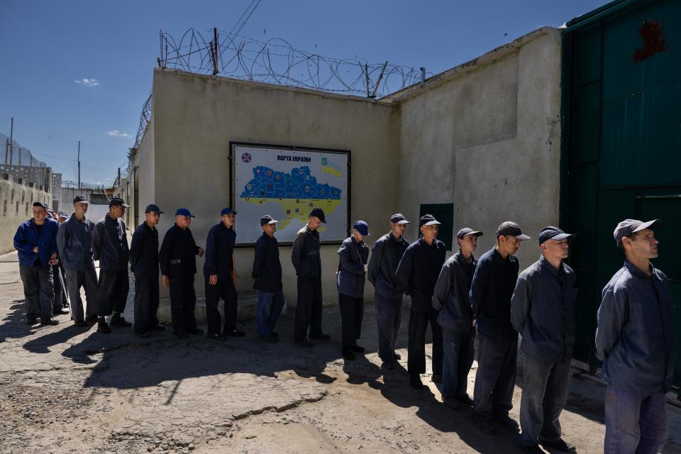 Prisoners line up for lunch outside the Russian prisoner of war detention camp on August 3, 2023, in the Lviv region, Ukraine. Hundreds of captured Russian POWs including conscripts, mercenaries, Wagner militia and Storm-Z Russian prisoners are being held in up to 50 sites around Ukraine. Storm-Z is a series of penal military units established by Russia since April 2023.