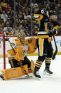 Nashville Predators goaltender Juuse Saros (74) makes a save behind Pittsburgh Penguins' Michael Bunting (8) during the second period of an NHL hockey game, Monday, April 15, 2024, in Pittsburgh. (AP Photo/Matt Freed)