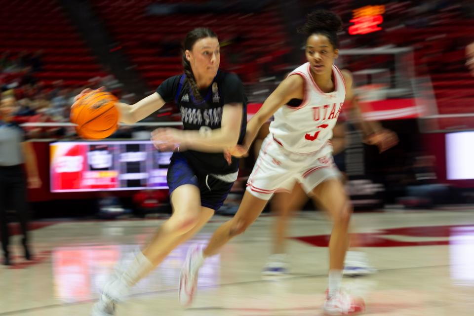 Weber State Wildcats guard Laura Taylor (0) dribbles the ball with Utah Utes guard Lani White (3) on defense during the women’s college basketball game between the University of Utah and Weber State University at the Jon M. Huntsman Center in Salt Lake City on Thursday, Dec. 21, 2023. | Megan Nielsen, Deseret News