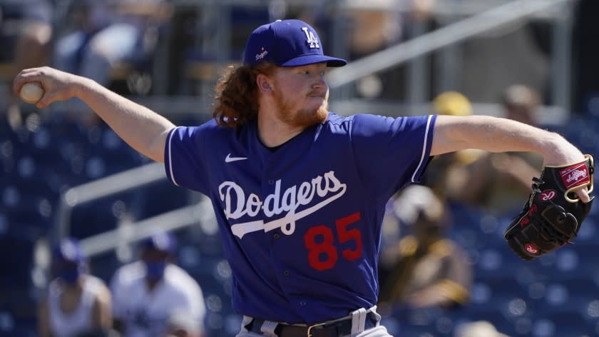 Los Angeles Dodgers' Dustin May pitches in the first inning of a spring training baseball game.