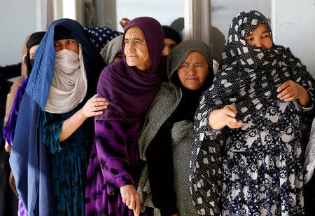 Afghan women line up to cast their votes during a parliamentary election at a polling station in Kabul, Afghanistan October 21, 2018. REUTERS/Omar Sobhani