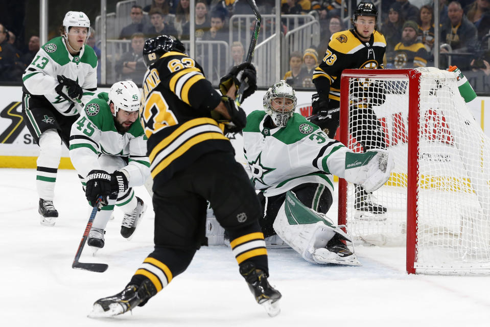 Boston Bruins' Brad Marchand (63) scores on Dallas Stars' Ben Bishop (30) during the second period of an NHL hockey game in Boston, Thursday, Feb. 27, 2020. (AP Photo/Michael Dwyer)