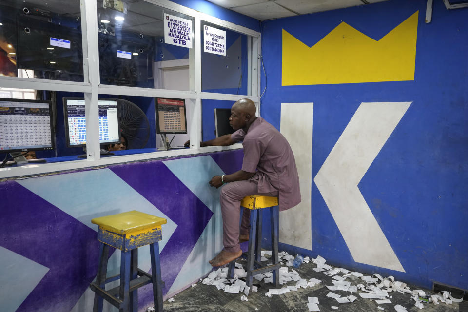 A man plays a World Cup betting game at a sports betting shop in Lagos, Nigeria, Monday, Dec. 5, 2022. Although sports betting is a global phenomenon and a legitimate business in many countries, the stakes are high on the continent of 1.3 billion people because of lax or non-existent regulation, poverty and widespread unemployment. (AP Photo/Sunday Alamba)