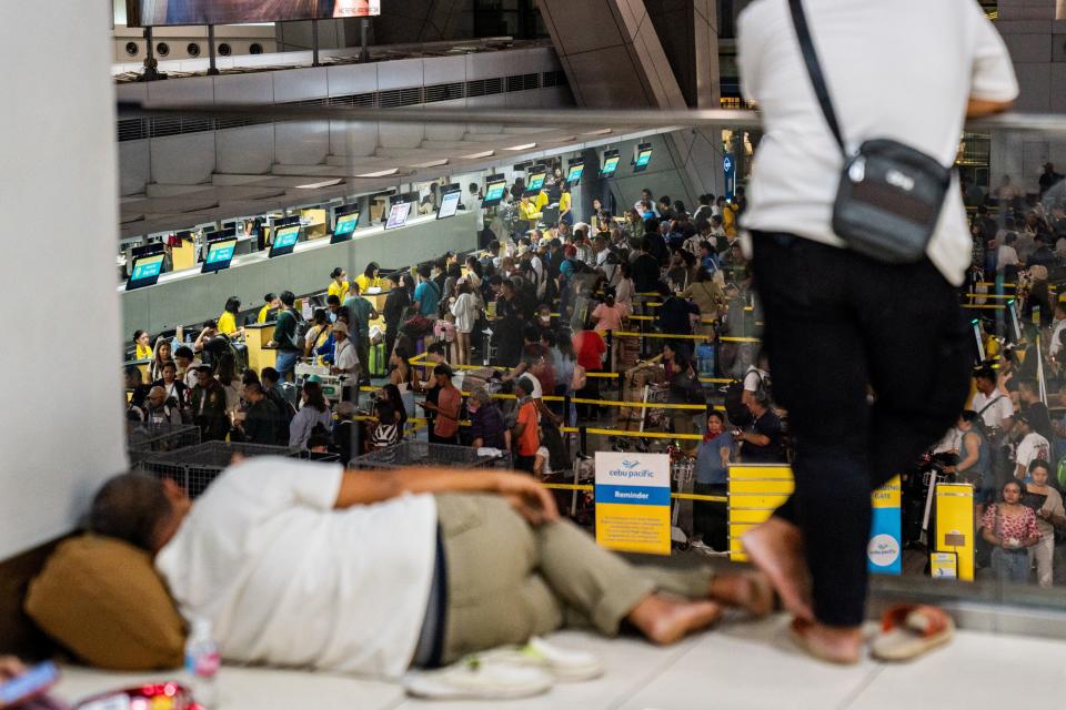 Passengers queue at airline counters at the Ninoy Aquino International Airport, in Pasay City, Metro Manila, Philippines, July 19, 2024.