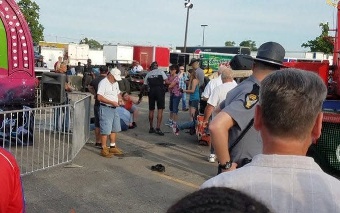 A person is attended to as authorities respond after the Fire Ball amusement ride malfunctioned injuring several at the Ohio State Fair - Credit: AP