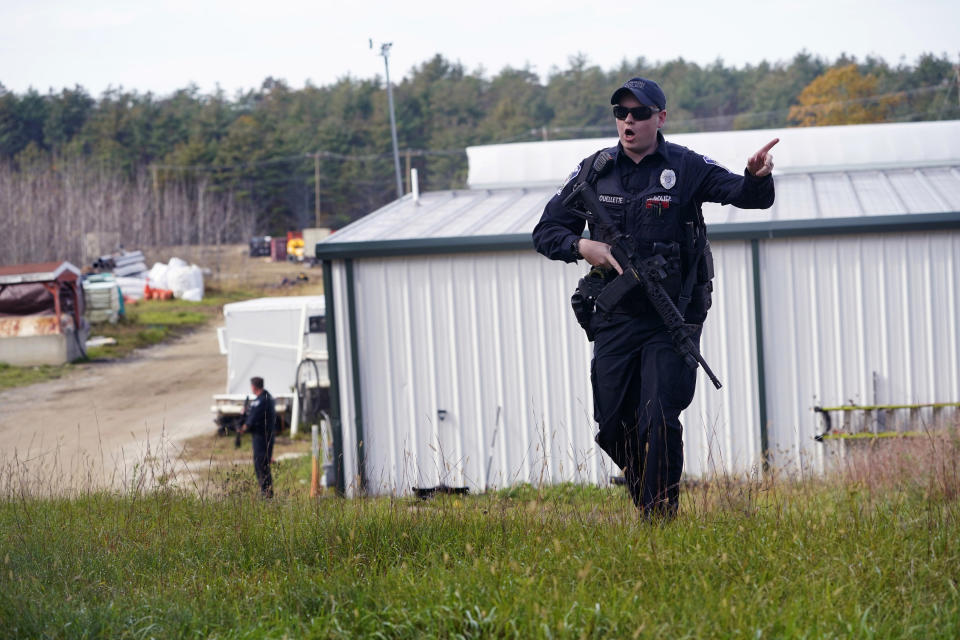 FILE - A police officer gives an order to the public during a manhunt for Robert Card at a farm following two mass shootings, Oct. 27, 2023, in Lisbon, Maine. Despite the warning by Card's friend and fellow Army reservist Sean Hodgson, which came alongside a series of other glaring red flags, Army officials discounted the warnings and ultimately did not stop Card from committing Maine's deadliest mass shooting when he killed multiple people in Lewiston. (AP Photo/Robert F. Bukaty, File)