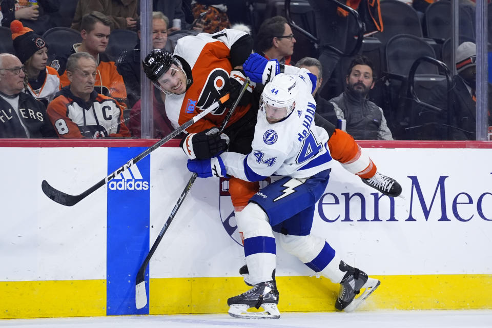 Tampa Bay Lightning's Calvin de Haan (44) and Philadelphia Flyers' Garnet Hathaway (19) collide during the second period of an NHL hockey game, Tuesday, Jan. 23, 2024, in Philadelphia. (AP Photo/Matt Slocum)