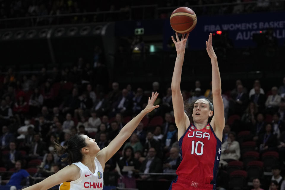 FILE - United States' Breanna Stewart, right, shoots over China's Zhang Ru during their gold medal game at the women's Basketball World Cup in Sydney, Australia, Saturday, Oct. 1, 2022. Brittney Griner back in the United States after her arduous 10-month saga in Russia while nearly half of the players in the WNBA have opted to continue to compete abroad this winter. (AP Photo/Rick Rycroft, File)