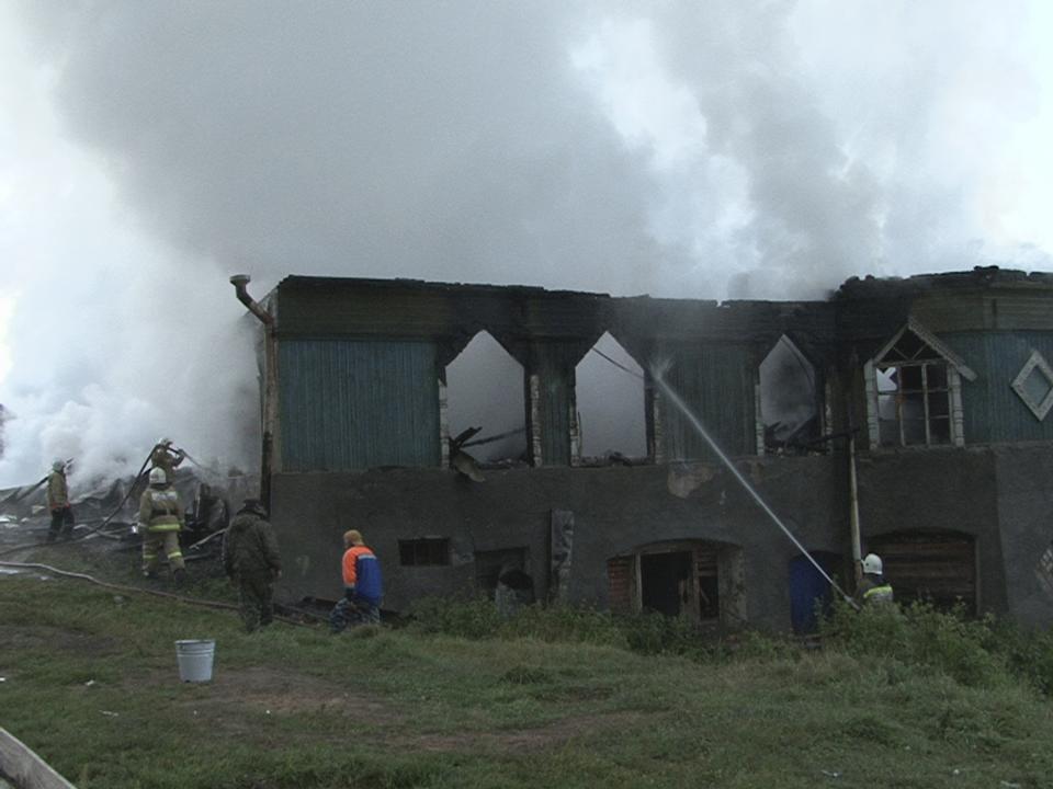 Firefighters work near a psychiatric hospital destroyed by fire in the Novgorod region town of Luka in this September 13, 2013 picture provided by the Russian Emergencies Ministry. The fire raged through the Russian psychiatric hospital on Friday, killing at least one person and leaving dozens missing as police searched the surrounding area for survivors, emergency and law enforcement officials said. Picture taken with a video camera. (REUTERS/Russian Emergencies Ministry of Novgorod region/Handout via Reuters)