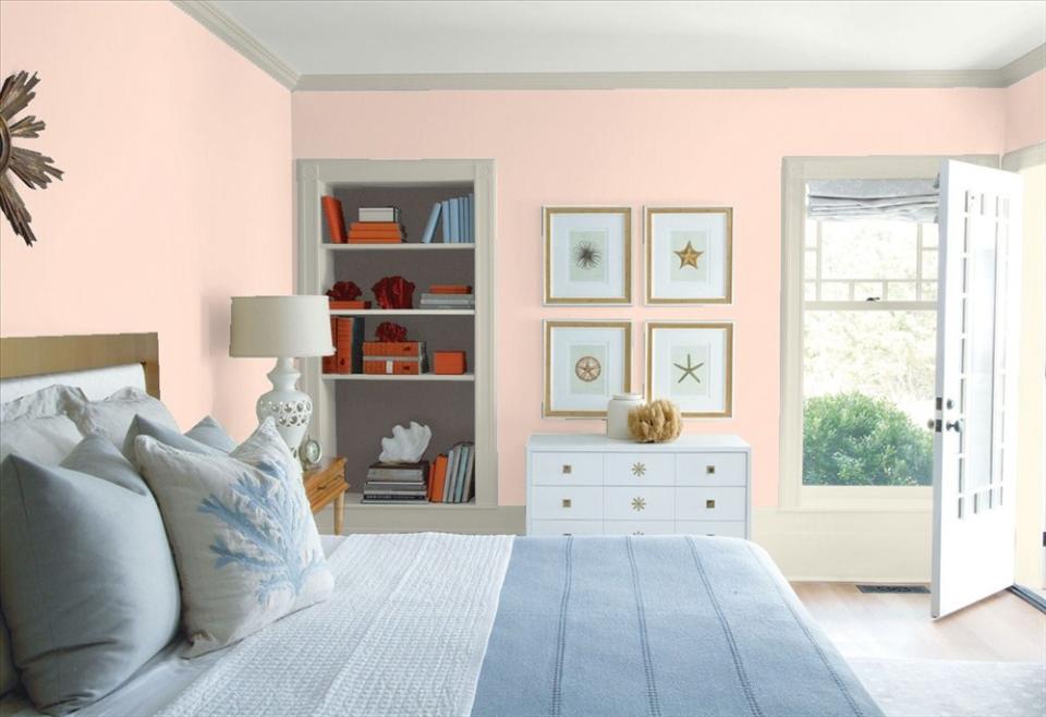 Sunlit coral gives a breezy beach feel to this bedroom.