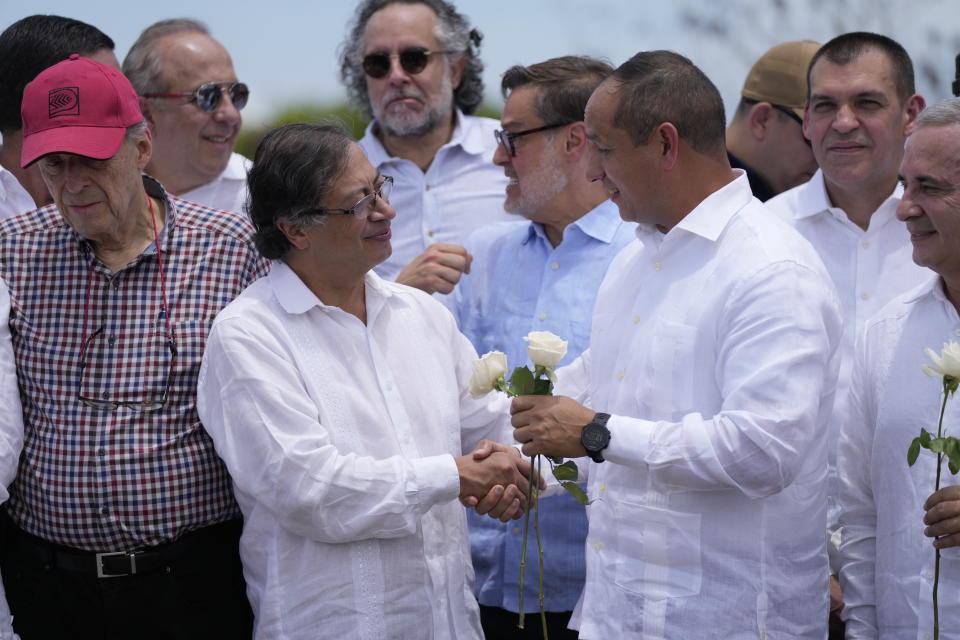 Colombia's President Gustavo Petro, left, and Venezuela's Transportation Minister Ramon Araguayan shake hands on the Simon Bolivar International Bridge during a ceremony to mark its reopening, between Cucuta, Colombia and San Antonio del Tachira, Venezuela, Monday, Sept. 26, 2022. Vehicles with merchandise will cross the bridge on Monday in a ceremonial act to seal the resumption of commercial relations between the two nations. (AP Photo/Fernando Vergara)