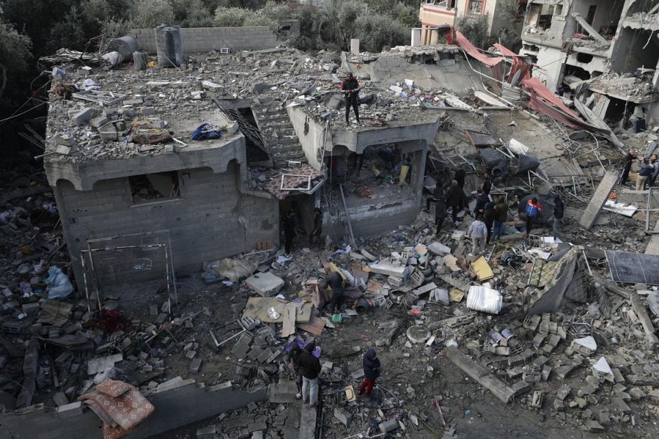 Palestinians search for bodies and survivors in the rubble of the destroyed house of the Manasra family following an Israeli airstrike in the southern Gaza Strip on Christmas Day (EPA)
