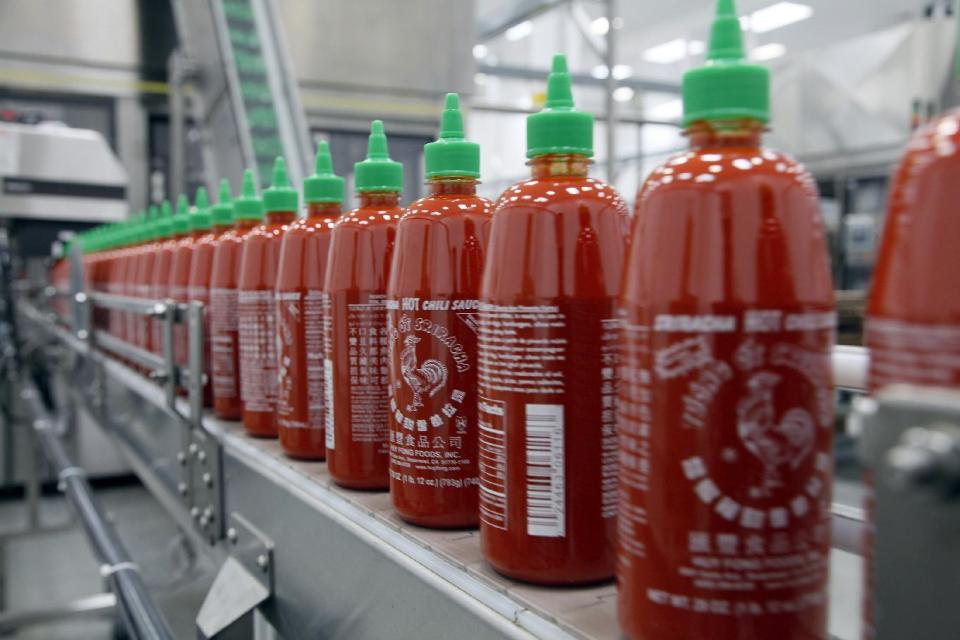 In this Tuesday, Oct 29, 2013, file photo, Sriracha chili sauce is produced at the Huy Fong Foods factory in Irwindale, Calif. The Commerce Department reports on wholesale prices for October on Thursday, Nov. 21, 2013. (AP Photo/Nick Ut, File)