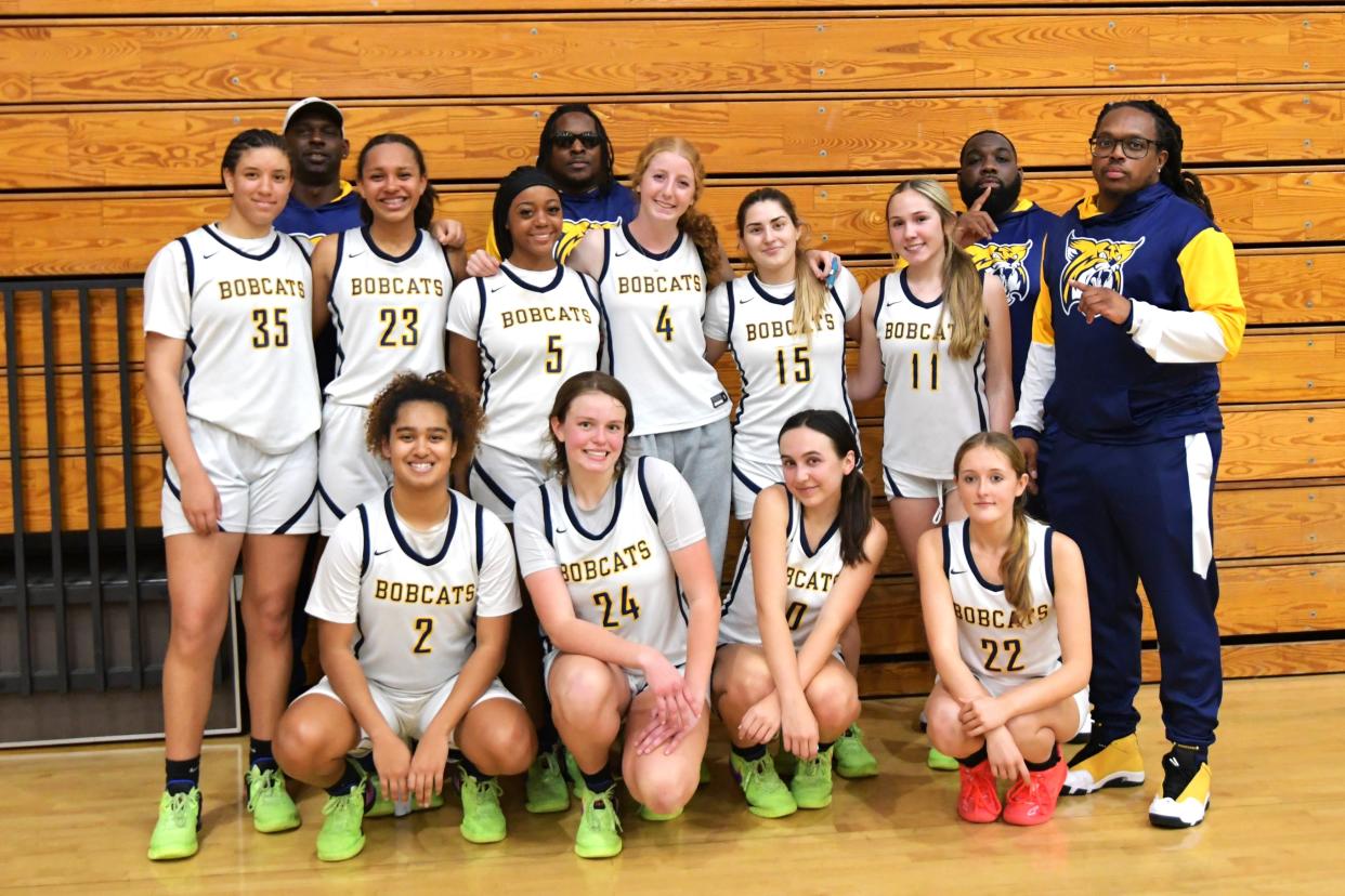 Boca Raton's girls basketball poses for a team photo following a regional playoff win against Miami on Feb. 19, 2024.