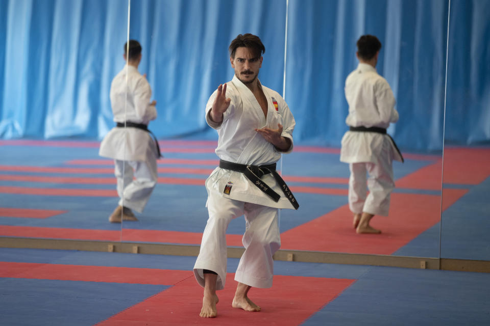 Spanish karate athlete Damian Quinteros, centre, trains in Madrid, Spain, Friday, Feb. 7, 2020. More than five years ago, one of Spain's most successful karate athletes was splitting his time between practice, school and his day job as an aeronautical engineer. Now, nearly five months before the Tokyo Games, Quintero is a full-time karateka and a top contender for the gold medal in Japan. (AP Photo/Paul White)