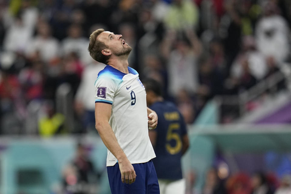 England's Harry Kane react after losing 1-2 against France during the World Cup quarterfinal soccer match between England and France, at the Al Bayt Stadium in Al Khor, Qatar, Sunday, Dec. 11, 2022. (AP Photo/Abbie Parr)